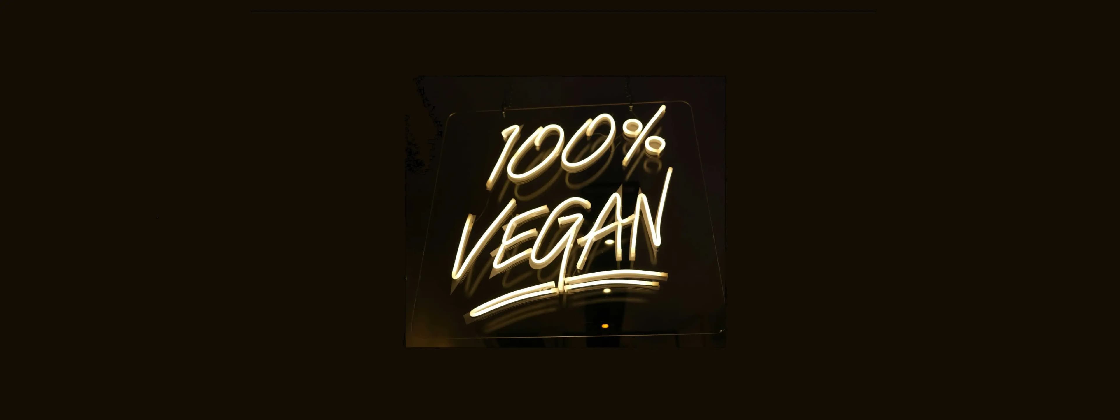 A neon sign with the words, 100% Vegan